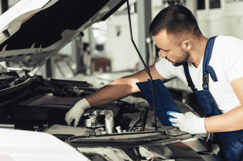 An engineer servicing a car